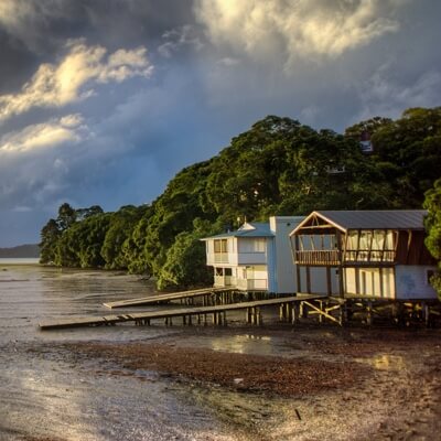 A small beachhouse very close to the water during evening time.